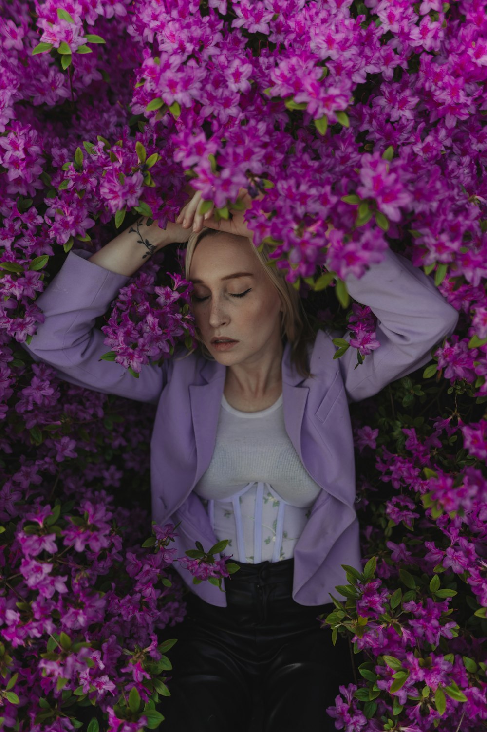 a woman standing in a field of purple flowers