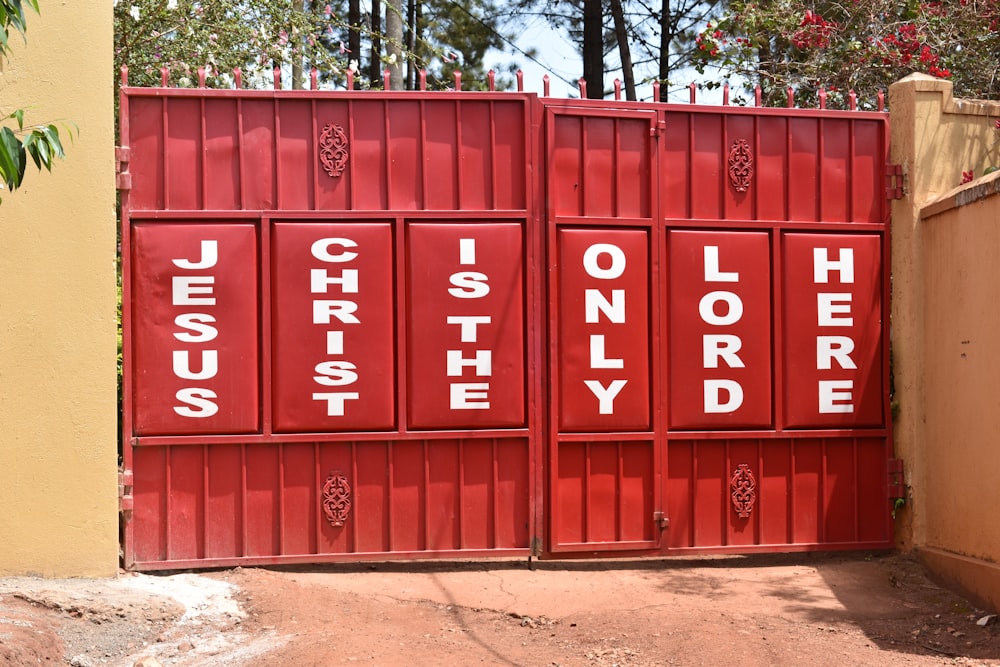 a red gate with white letters on it