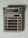 A beige calculator with multiple buttons, featuring a display that shows the number 3.14. The calculator has a solar panel and various function keys, including numerical digits, mathematical operations, and memory functions.