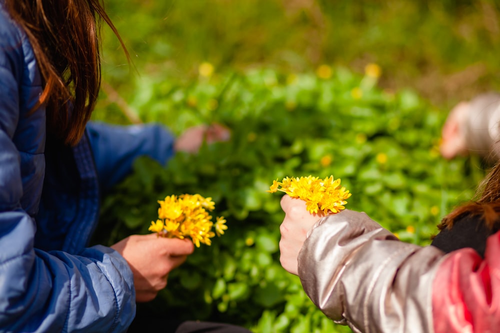 a couple of people that are holding some flowers