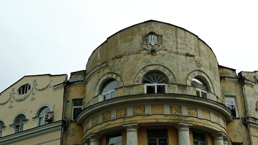 an old building with a clock on the top of it