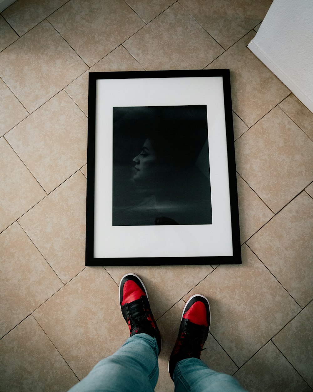 a person standing in front of a picture on the floor
