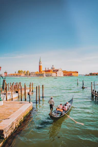 a gondola on the water near a pier