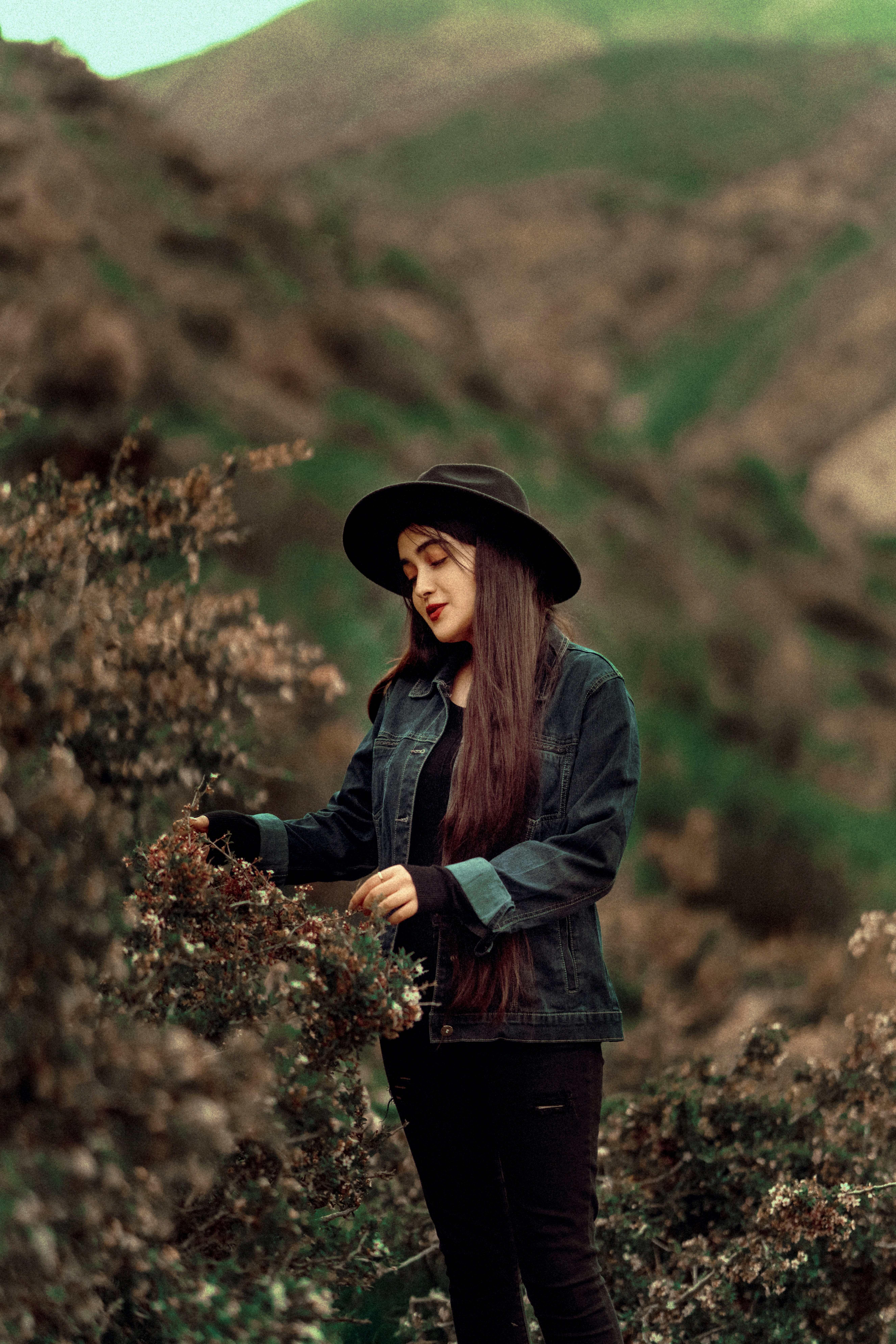 A woman with long hair wearing a black hat photo – Free Girl Image on ...
