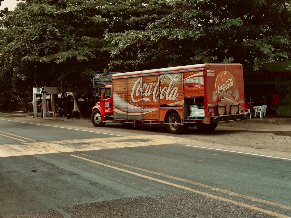a coca cola truck parked on the side of the road