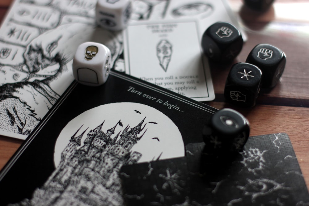 a game of dice and a book on a table