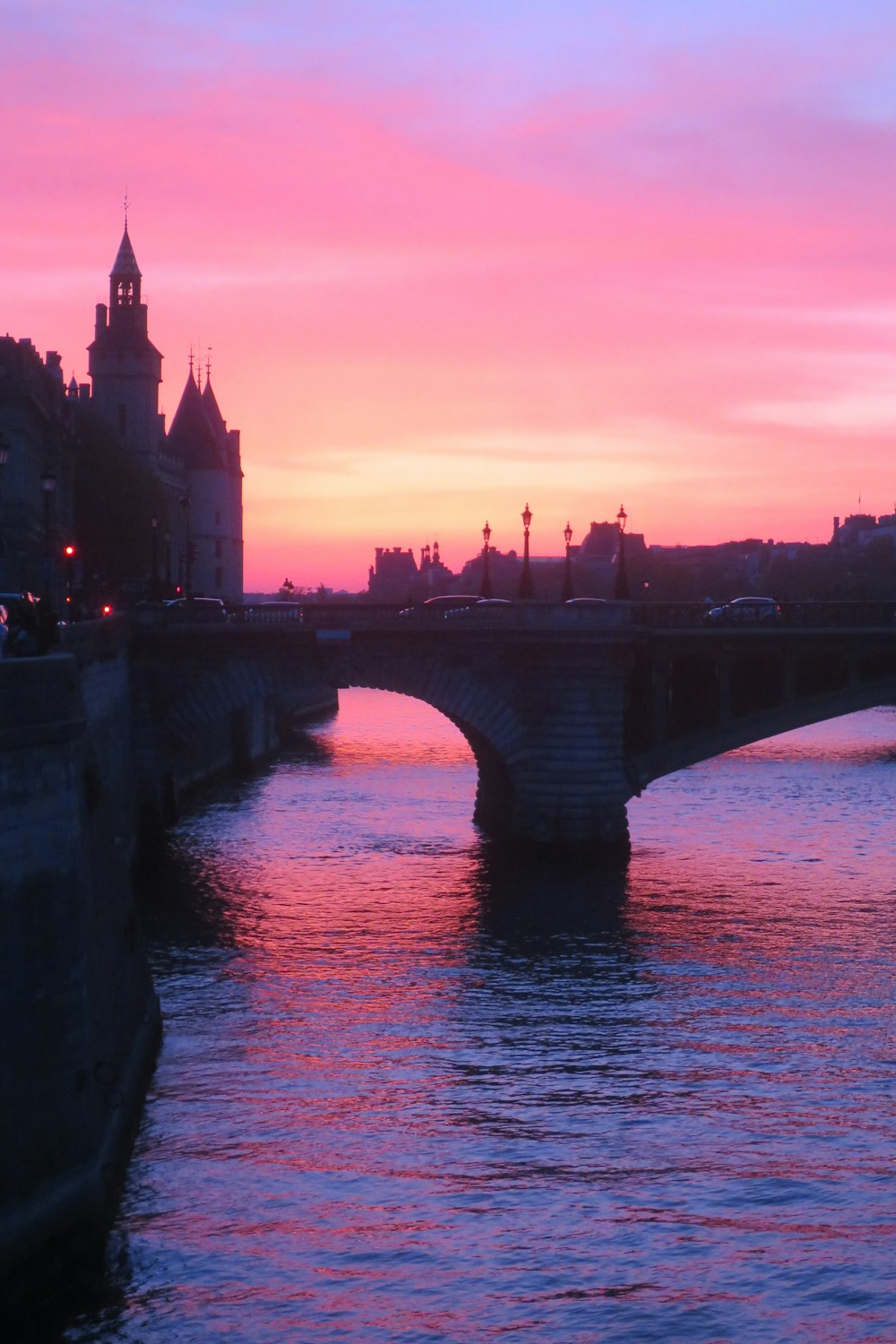 a bridge over a body of water at sunset