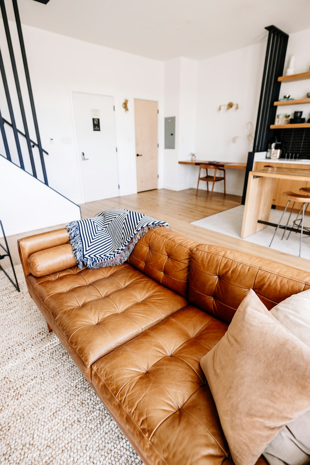 a brown leather couch sitting in a living room