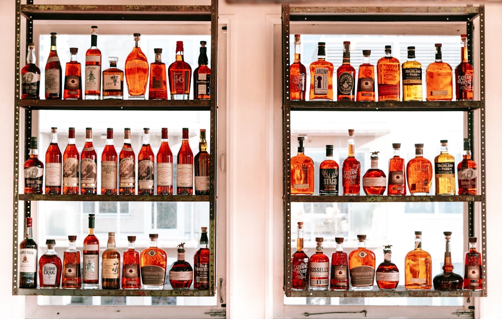 two shelves filled with different types of liquor
