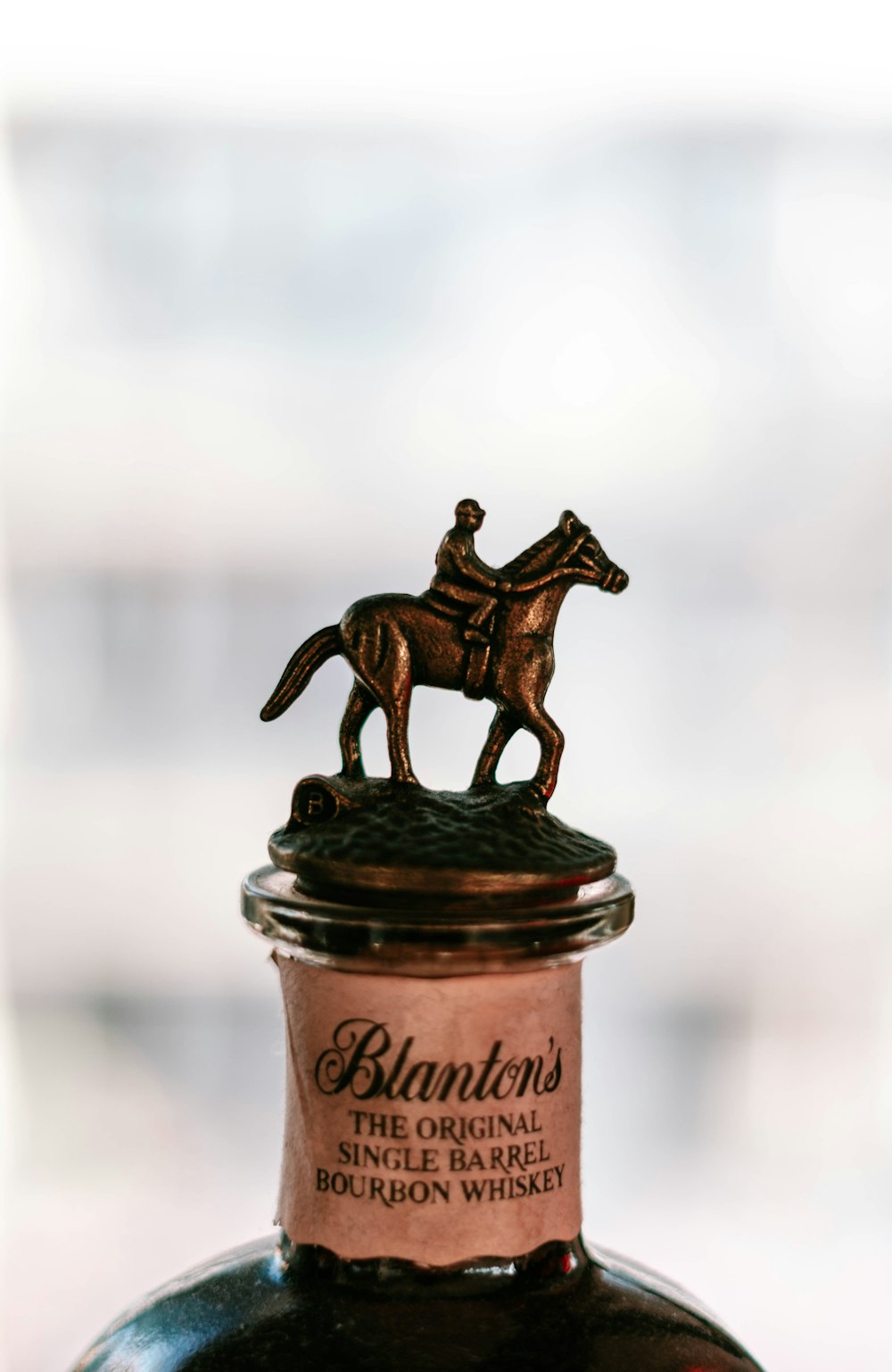 a bottle of liquor with a horse on top of it