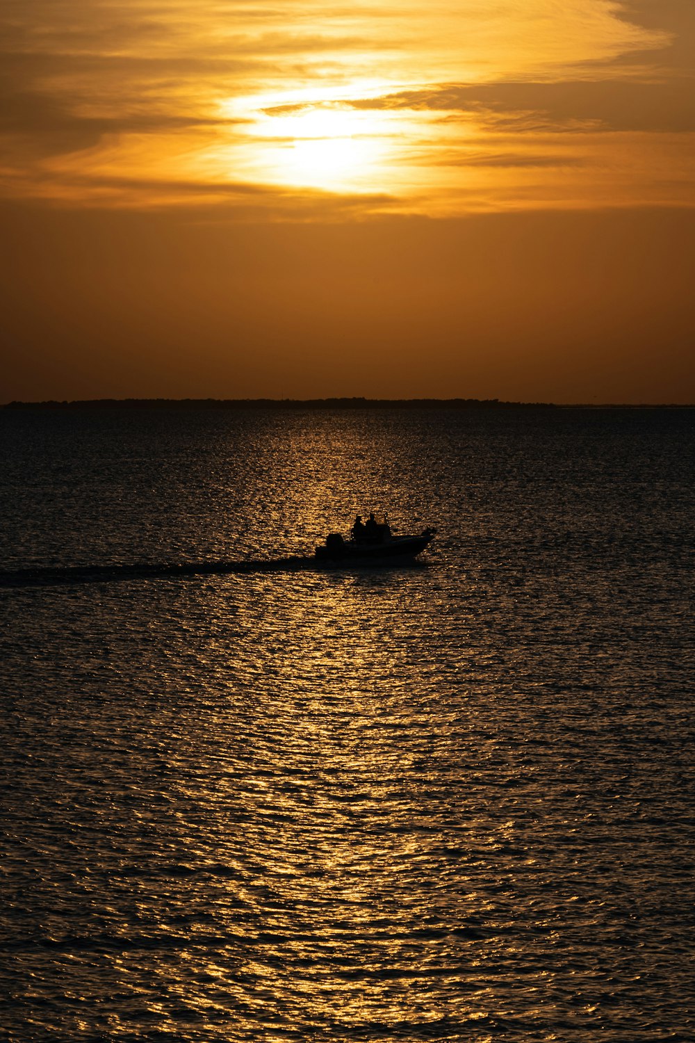 a small boat in the middle of a large body of water