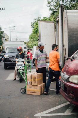 a group of people loading boxes onto a truck
