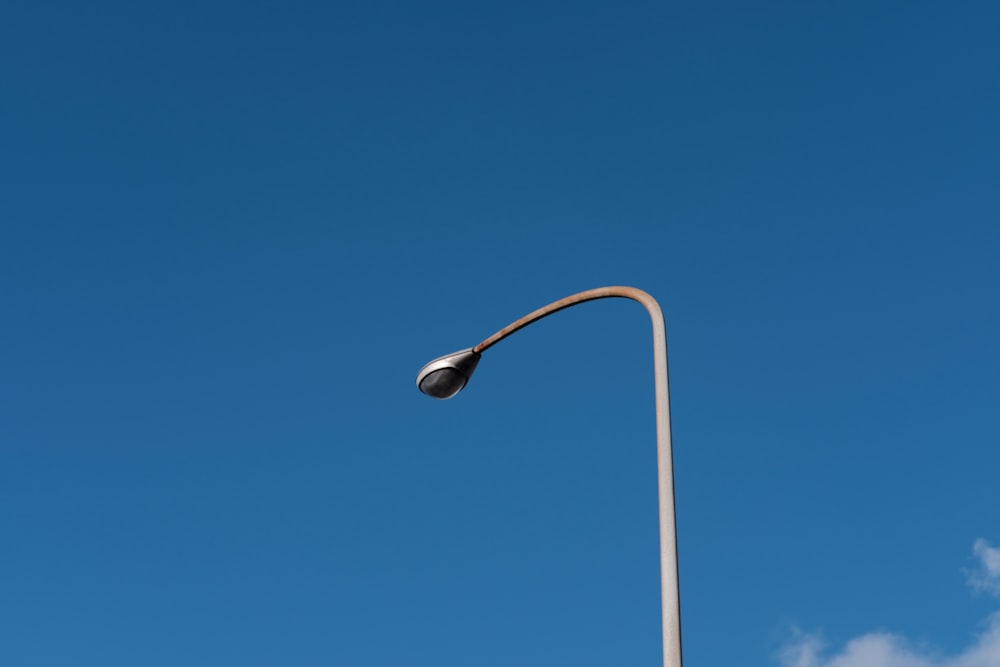 a street light with a blue sky in the background