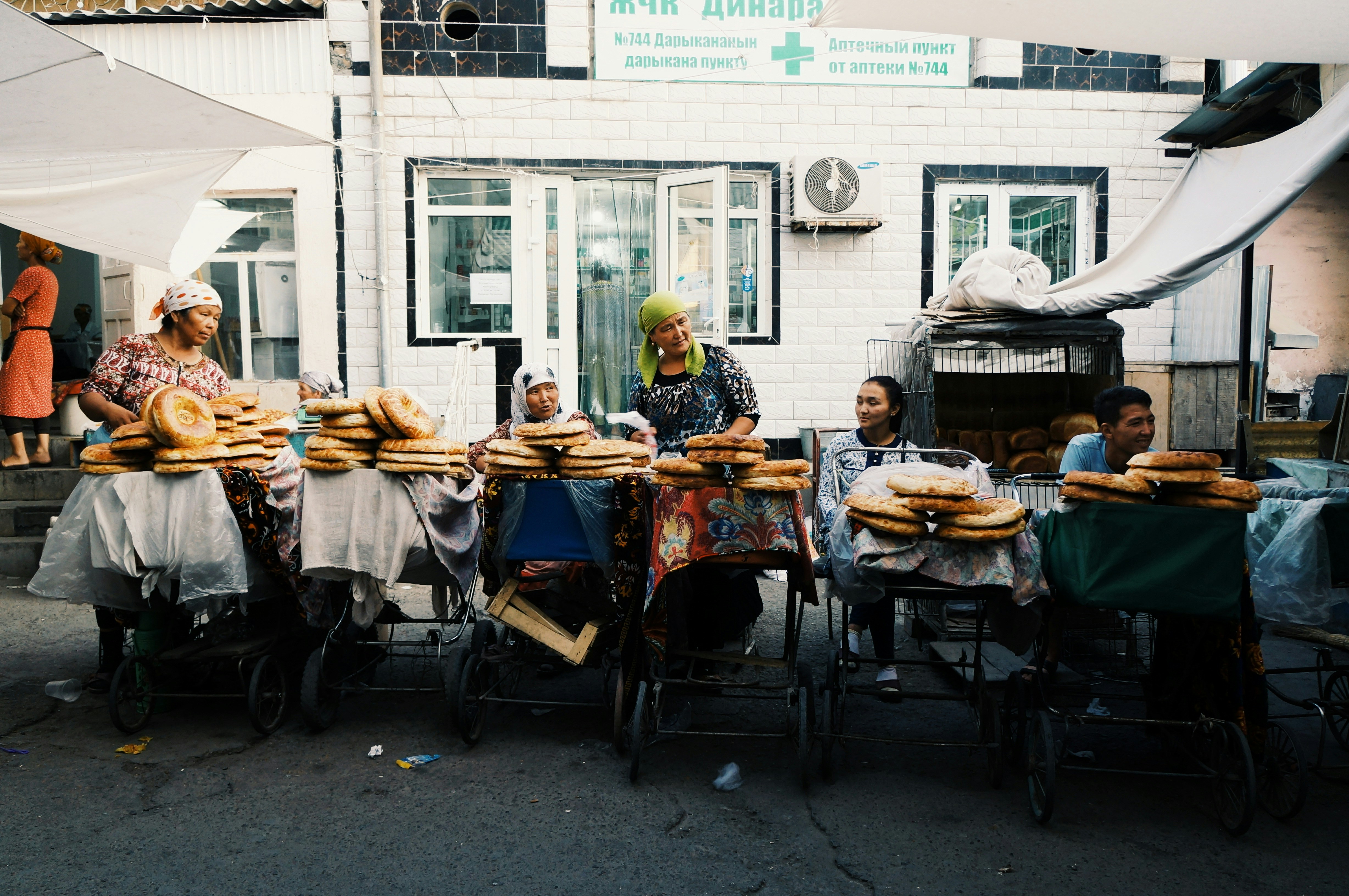 a group of people sitting around a table filled with donuts