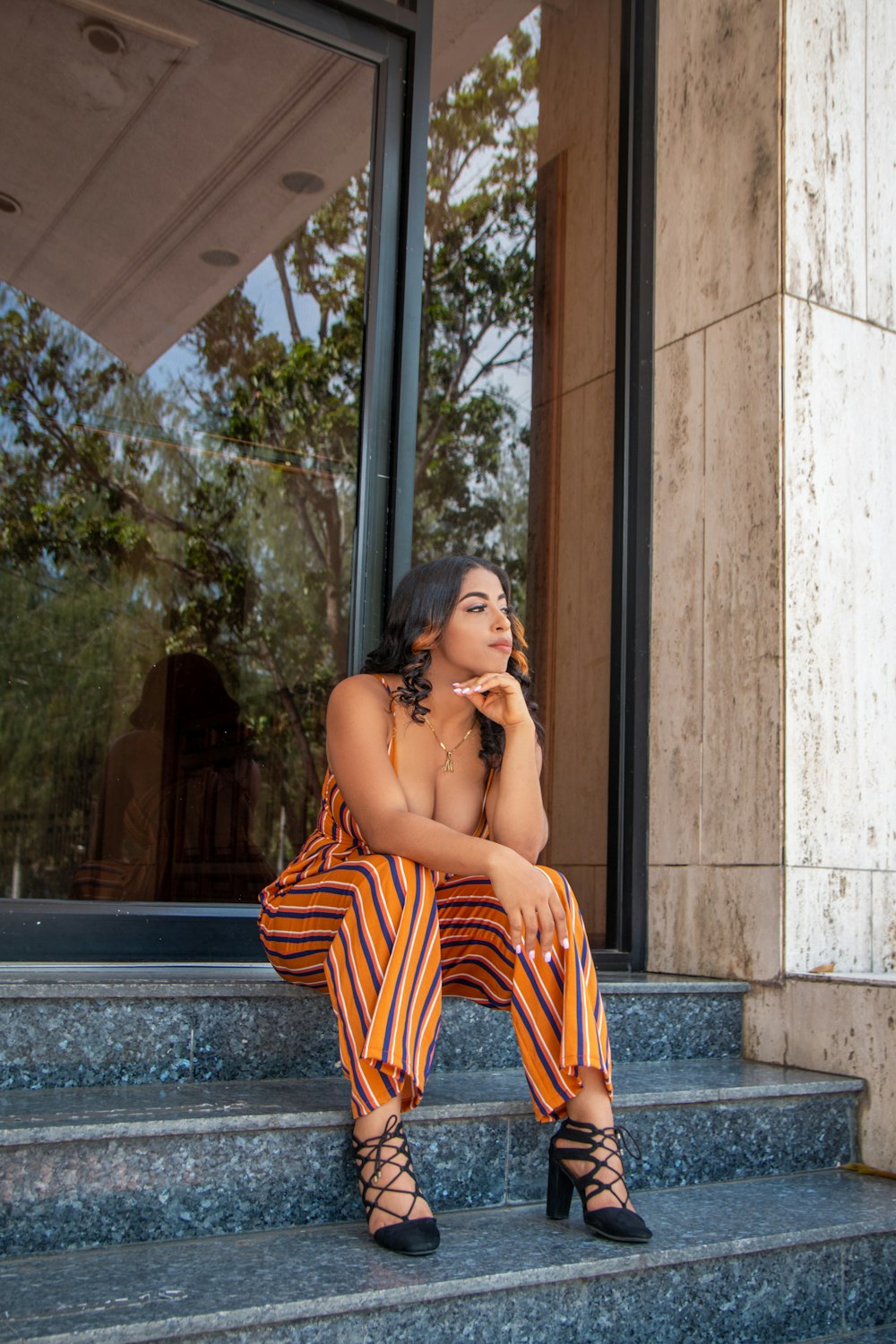 a woman sitting on the steps of a building