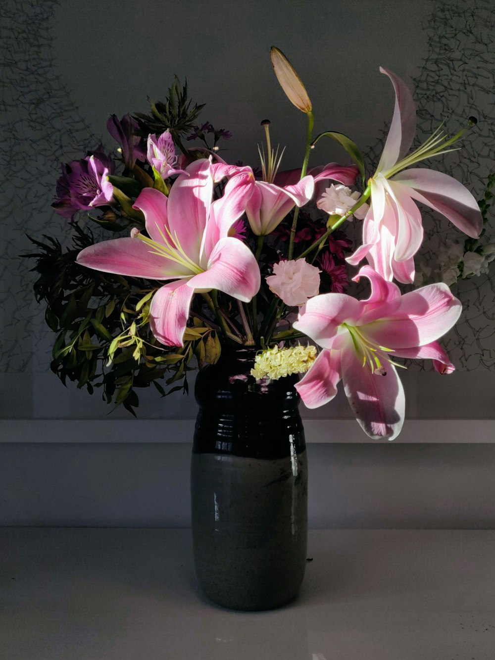 a vase filled with pink flowers on top of a table