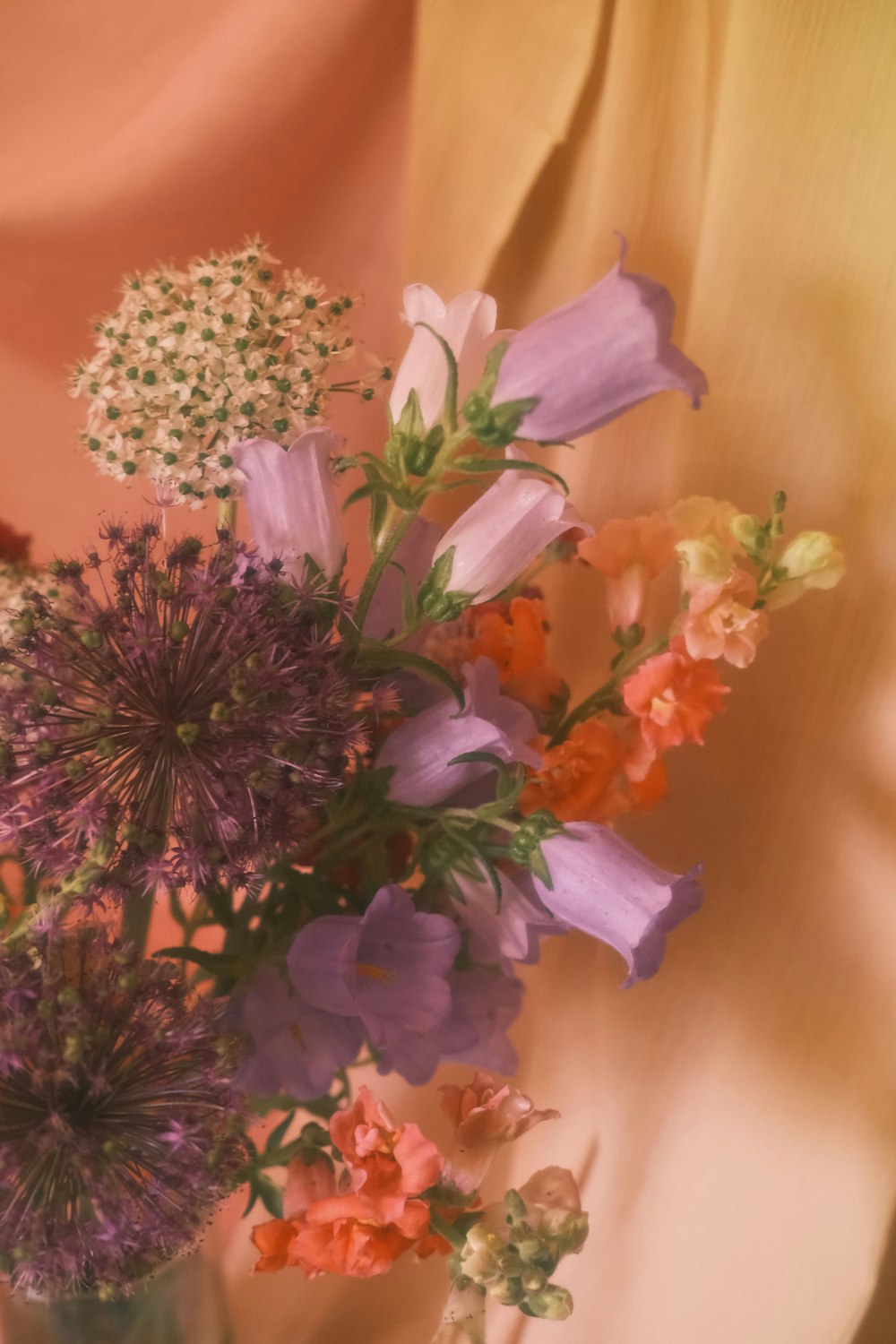 a vase filled with lots of different colored flowers