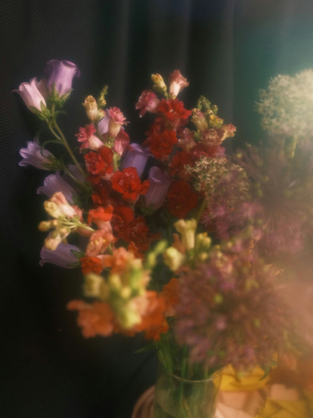 a vase filled with lots of colorful flowers