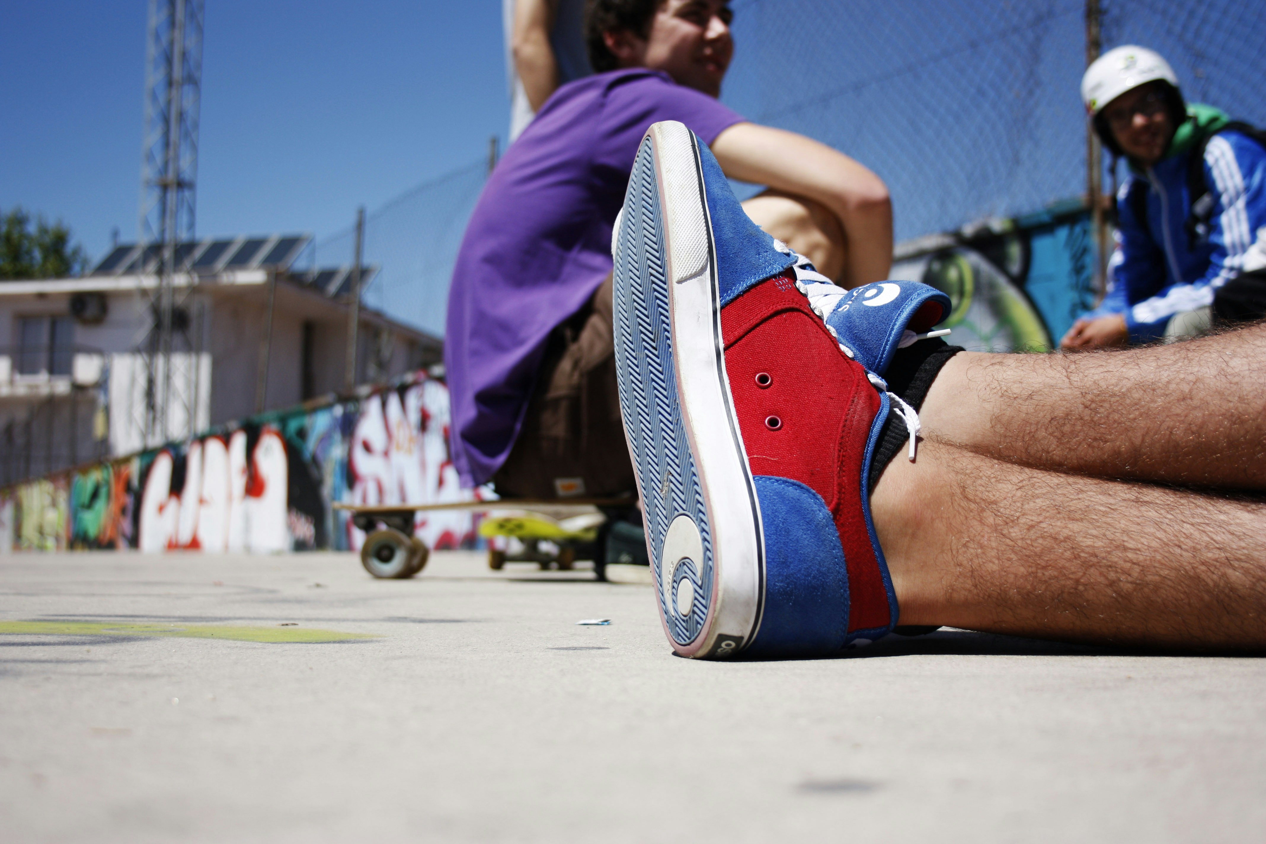 A stylish pair of shoes placed next to a variety of outfits