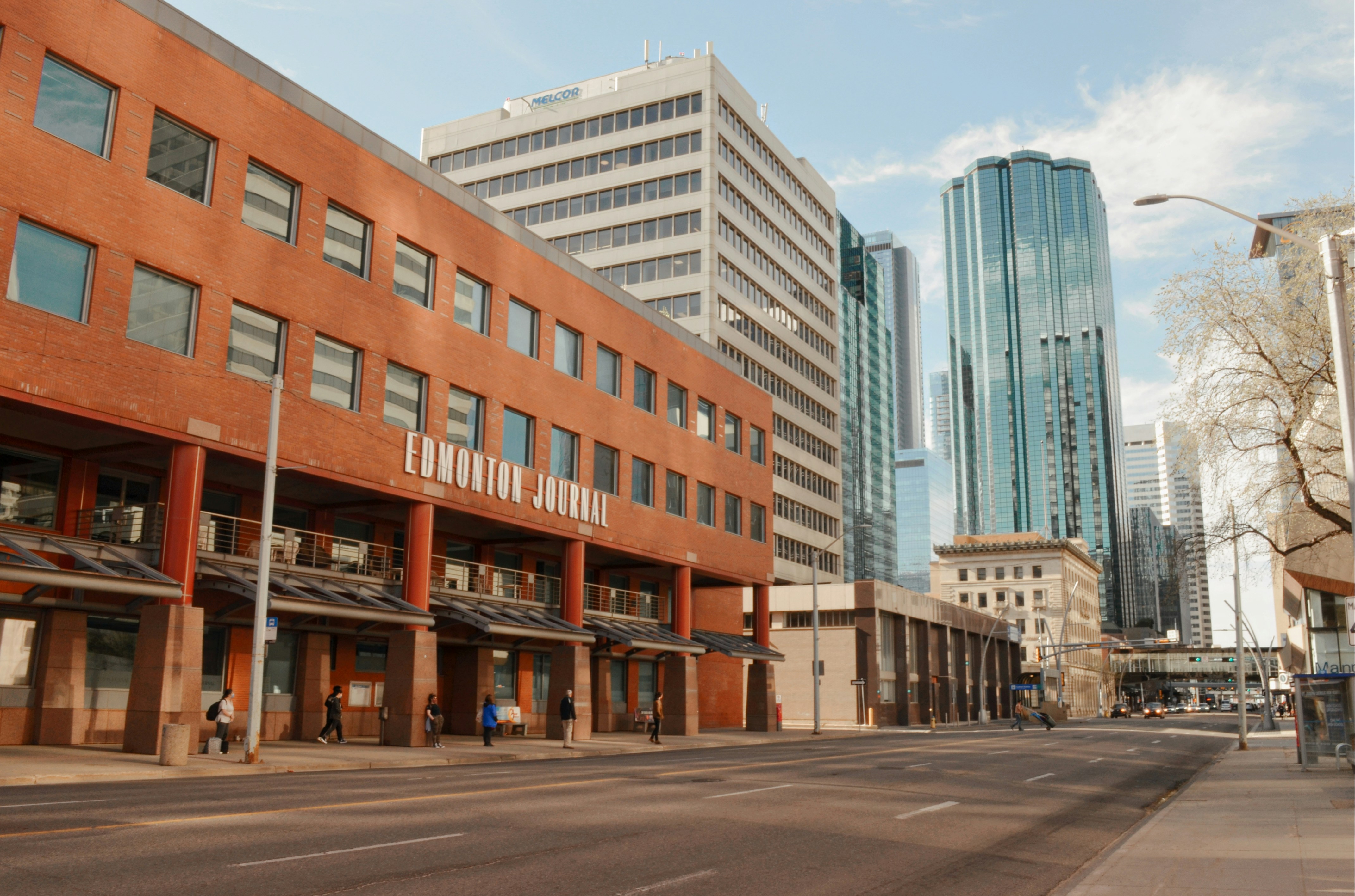 a city street with tall buildings in the background