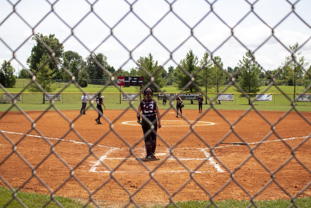 a group of people playing a game of baseball on a field