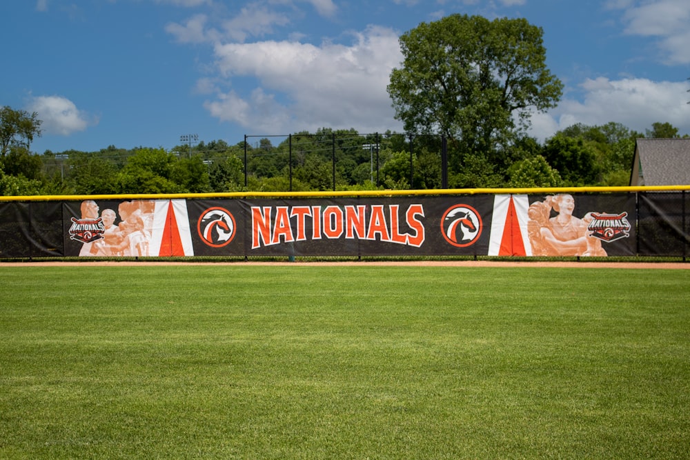 a baseball field with a national banner on it