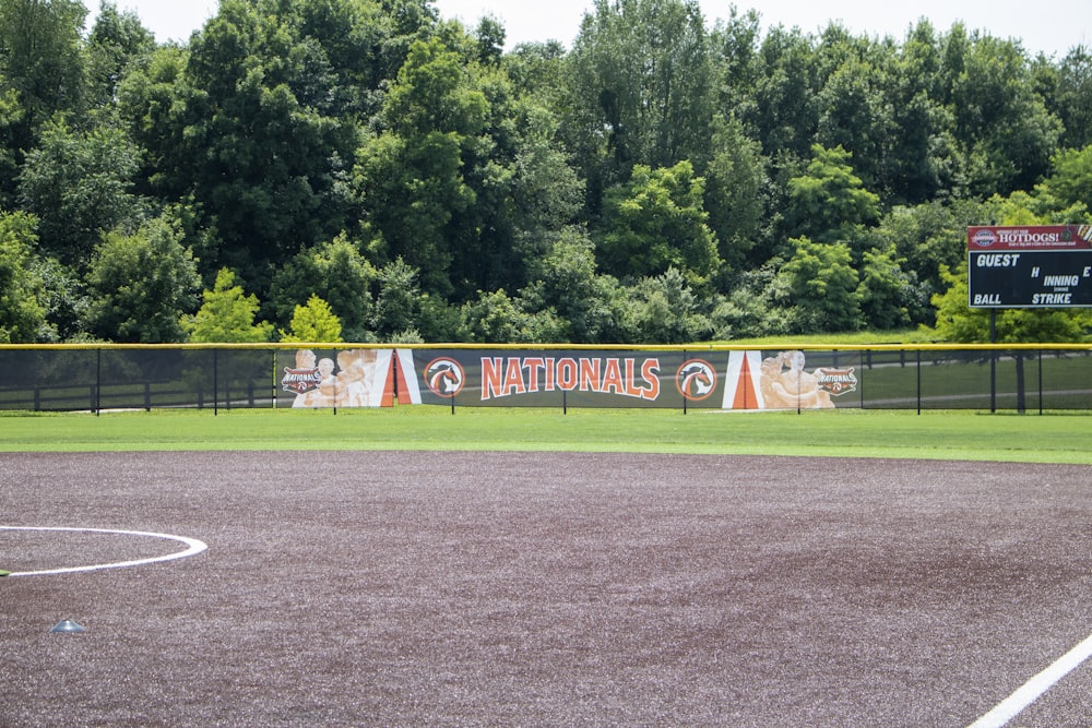 a baseball field with trees in the background