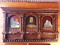 Chinese zodiac symbols carved into a traditional wooden panel.