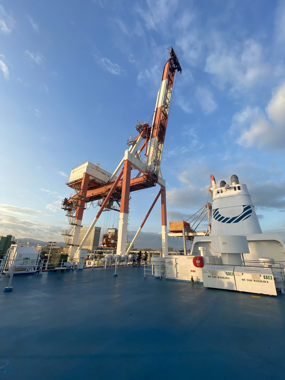 a large crane sitting on top of a boat in the ocean