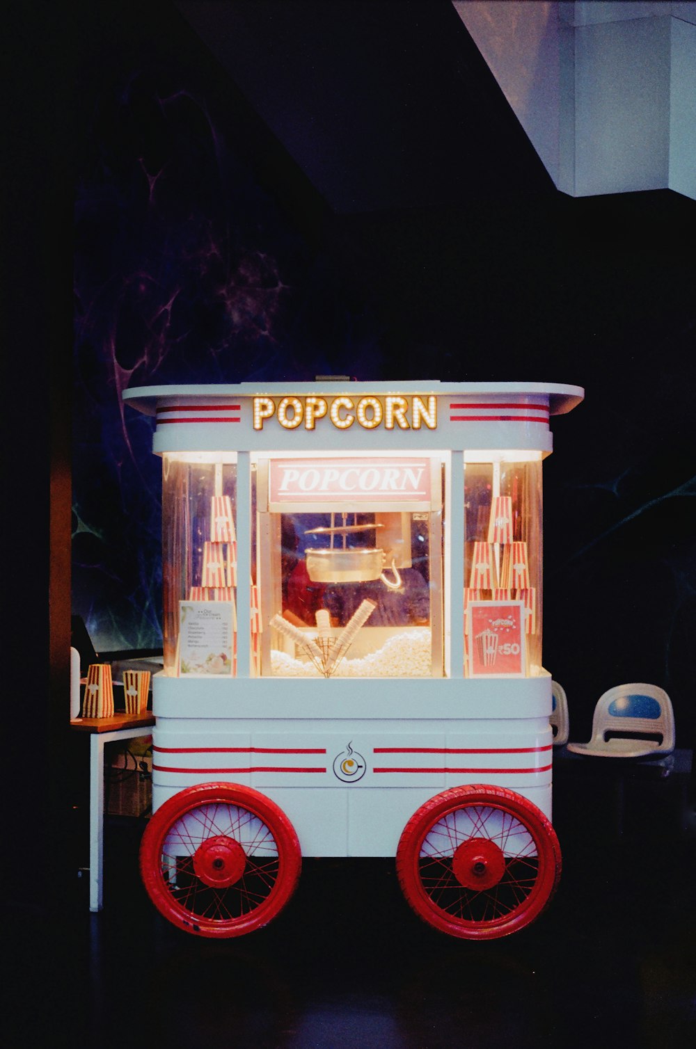a small popcorn cart sitting on top of a table