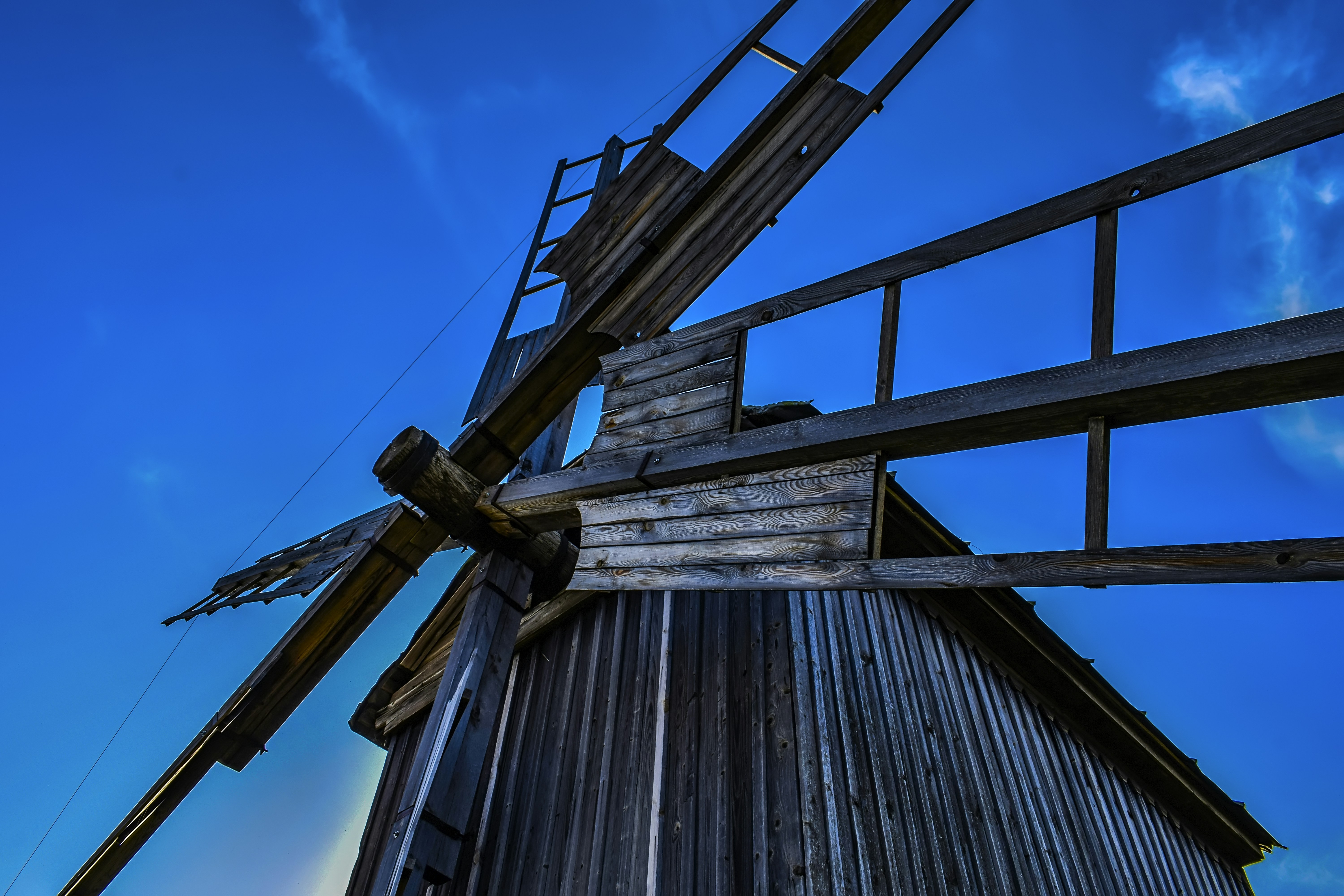 woman wearing yellow long-sleeved dress under white clouds and blue sky during daytime