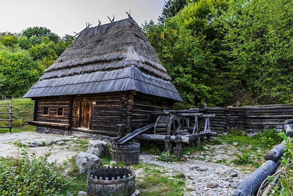 an old wooden house with a thatched roof