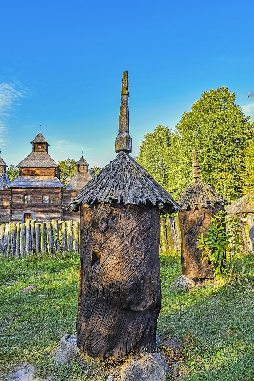 a wooden structure in the middle of a field