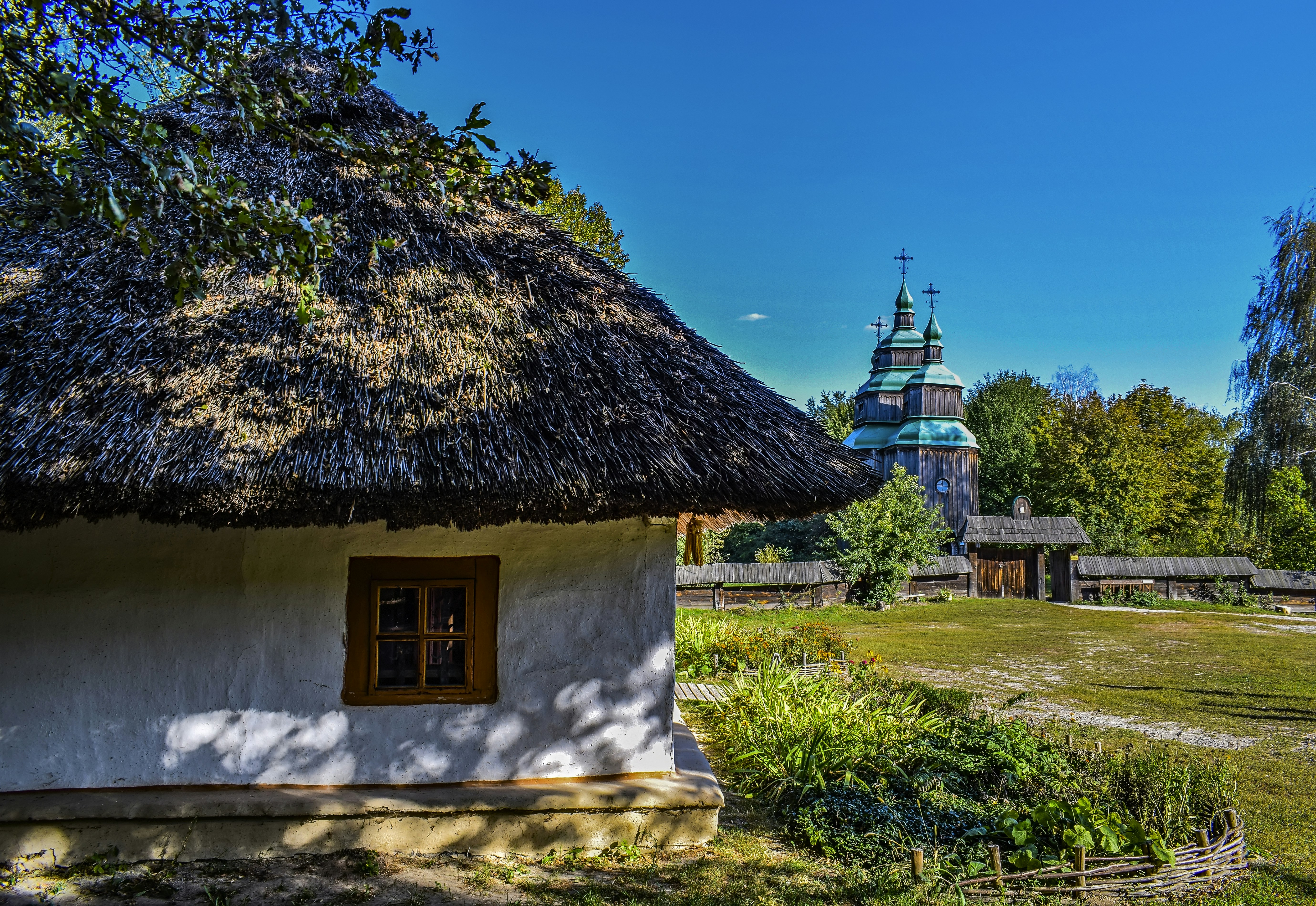 a small white house with a thatched roof