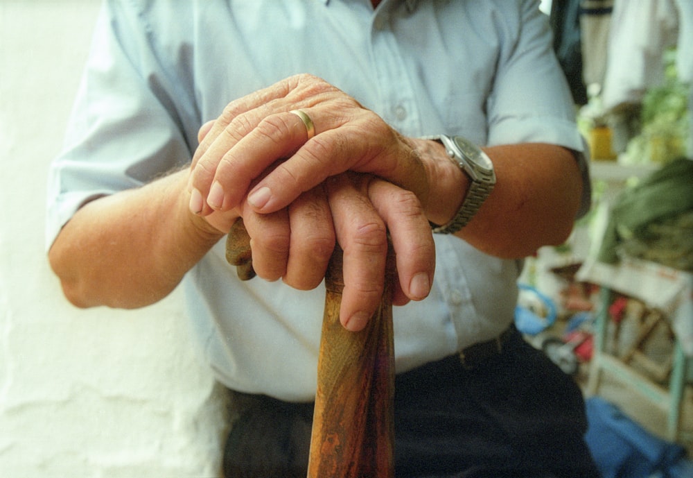 a man holding a wooden stick in his hands