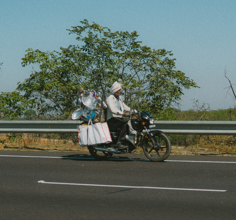 a man riding a motorcycle down a highway