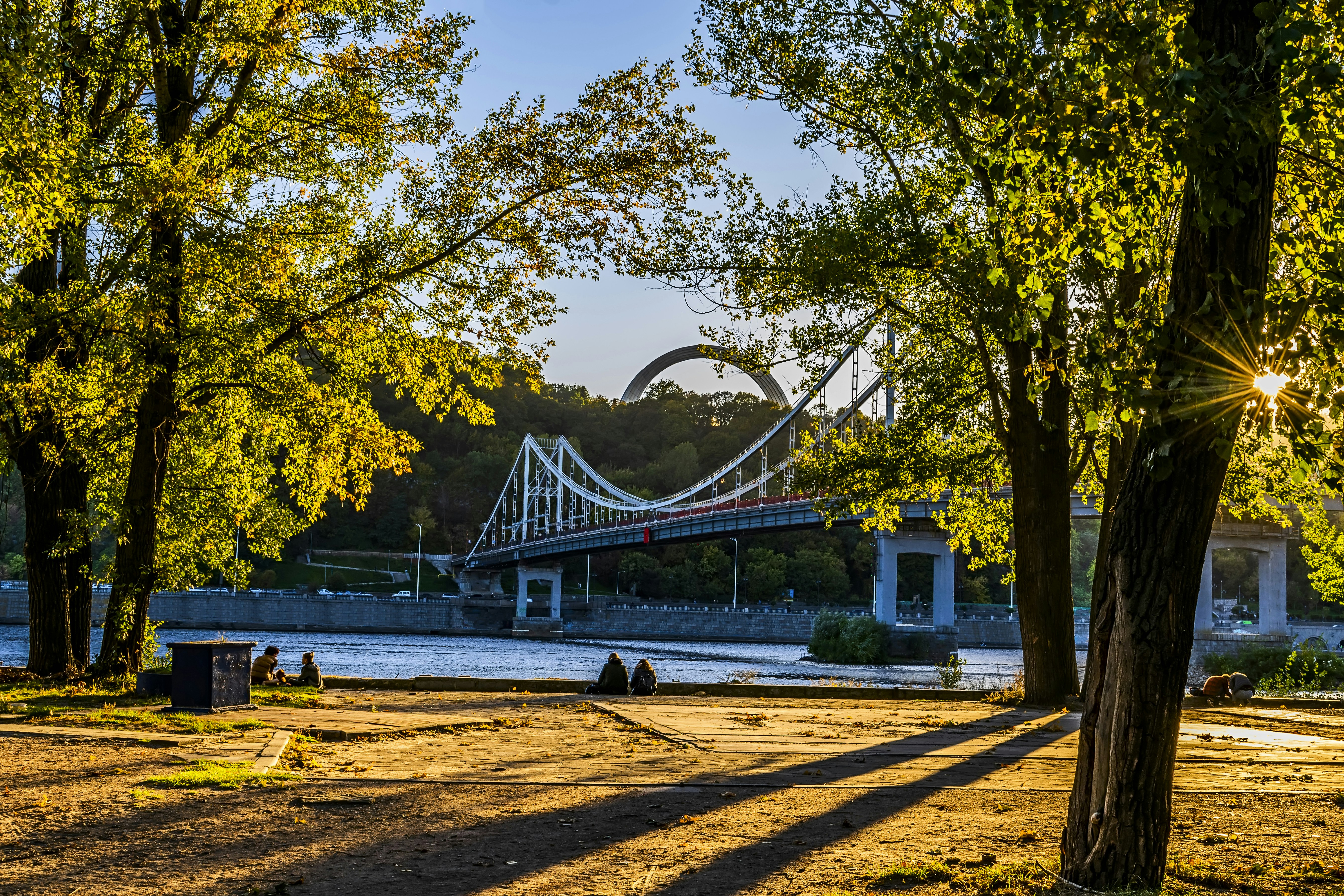 a bridge over a body of water surrounded by trees