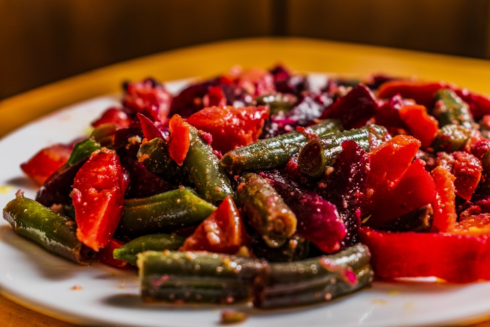 a white plate topped with sliced up vegetables