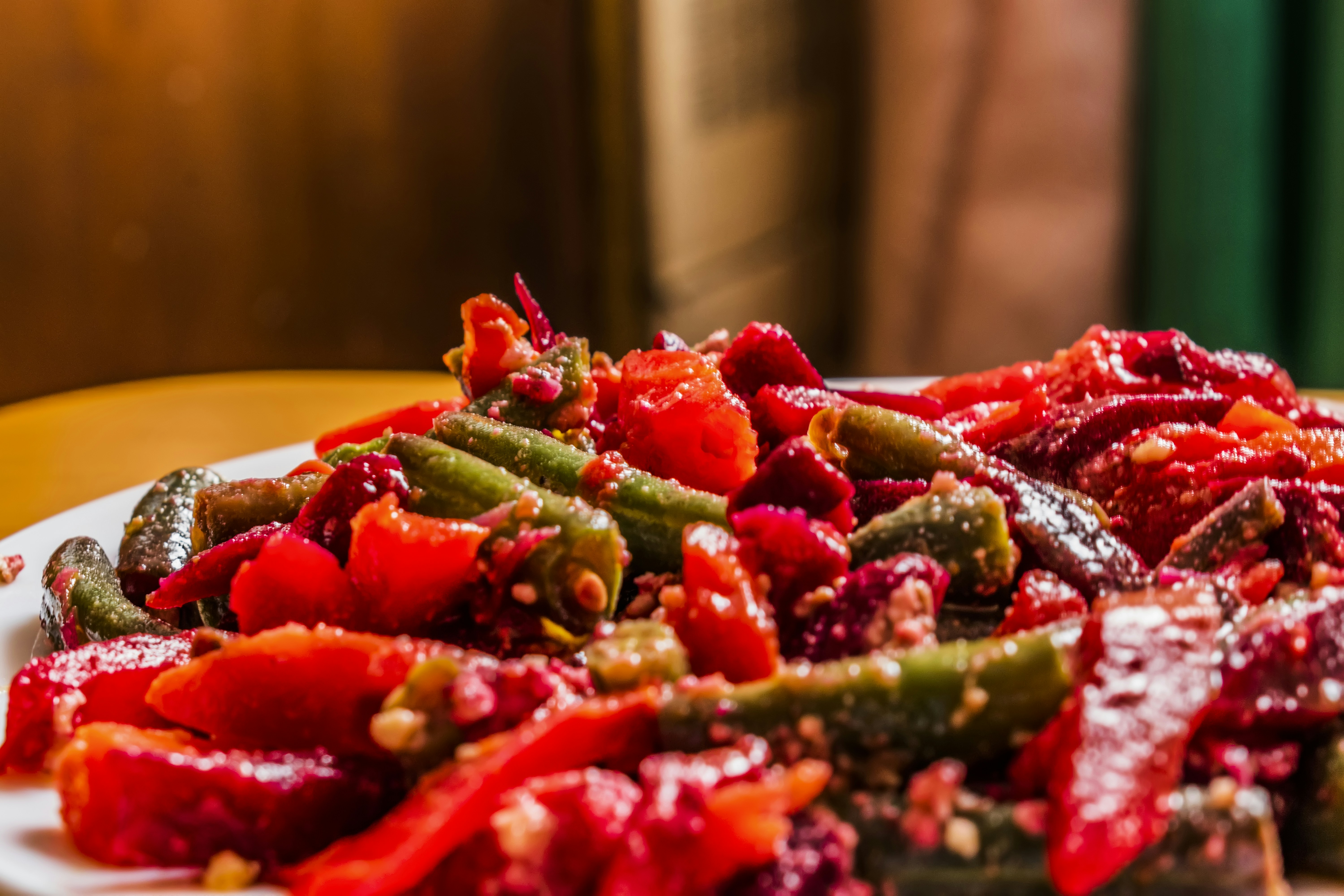 a white plate topped with red and green vegetables