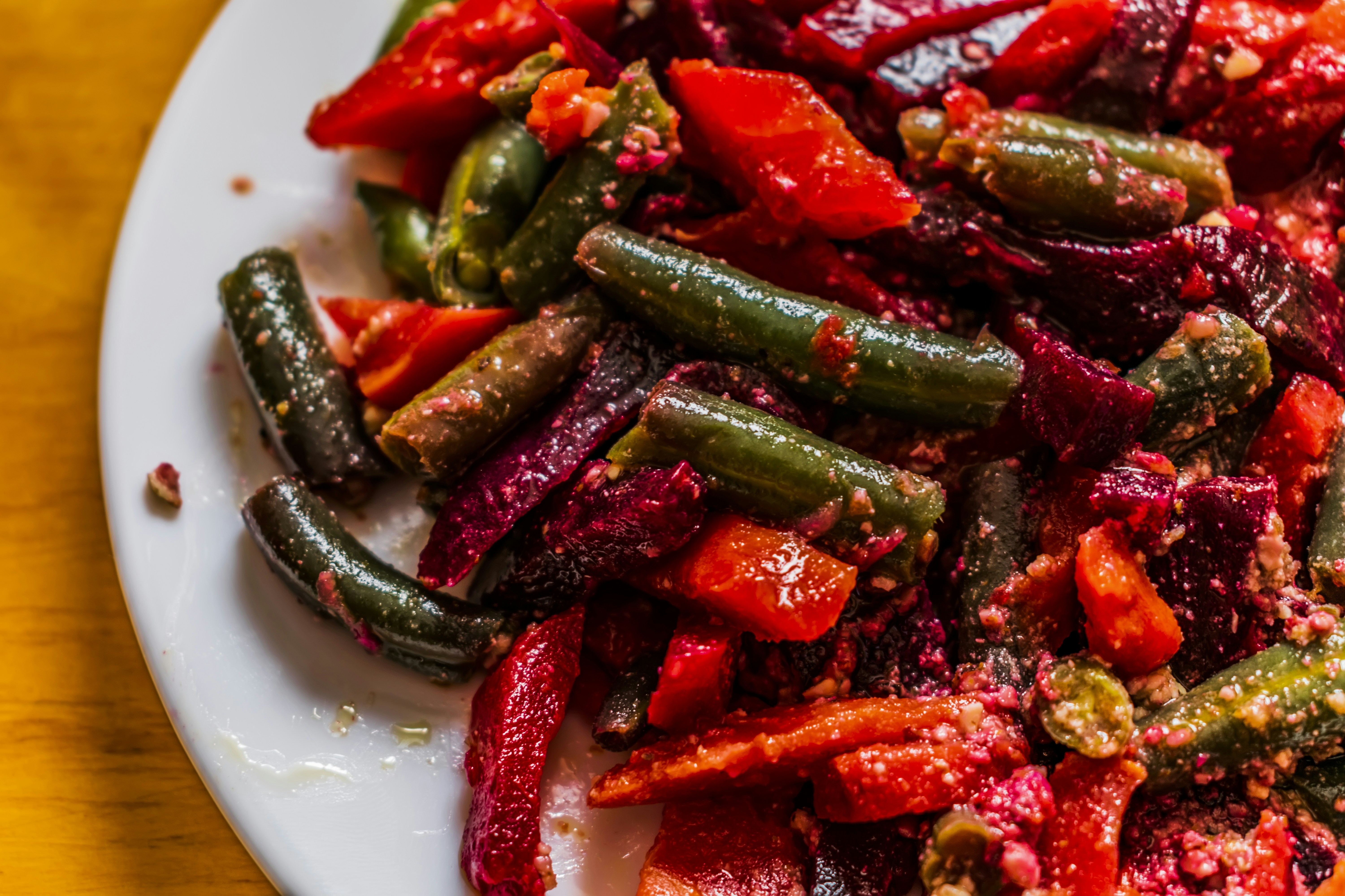 a white plate topped with red and green vegetables