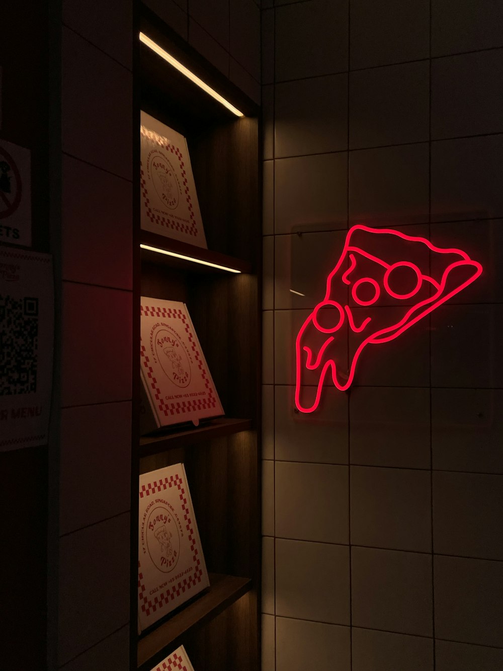 a red neon sign that is on a wall