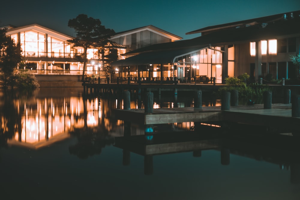 a large house sitting on top of a lake at night