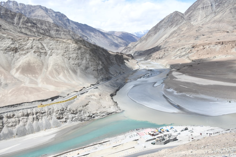 a river running through a valley surrounded by mountains