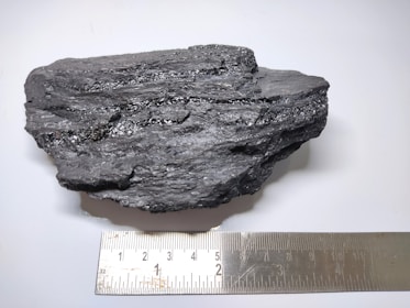 a piece of rock next to a ruler