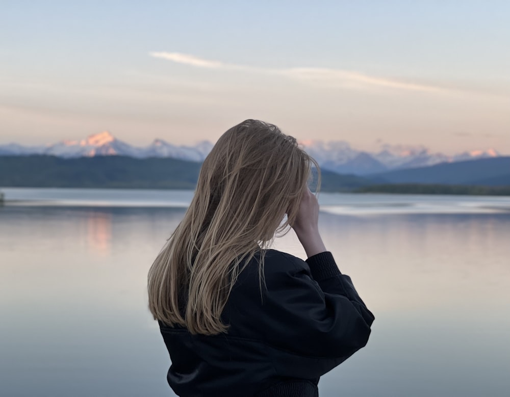 a woman looking out over a body of water