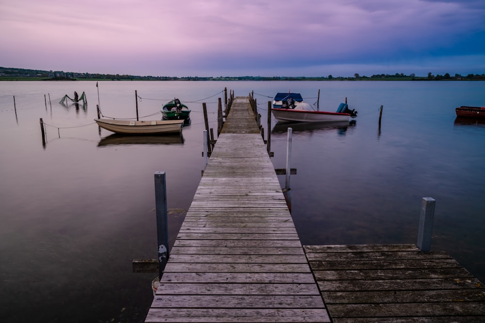 un quai sur un lac avec plusieurs bateaux