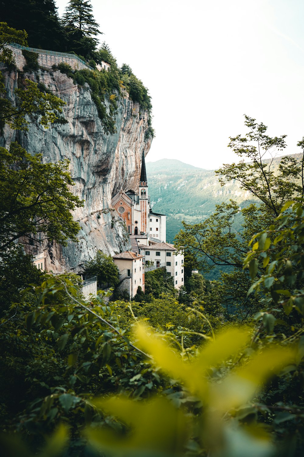 a castle perched on top of a cliff surrounded by trees