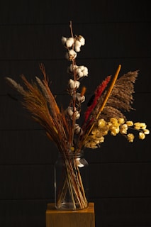 Elegant arrangement of sunflowers and daisies in a rustic vase