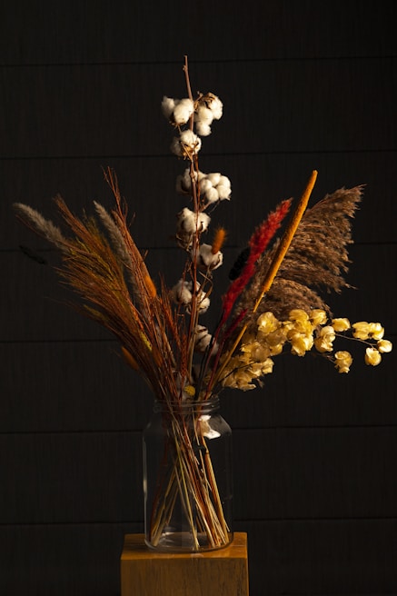 Elegant arrangement of sunflowers and daisies in a rustic vase