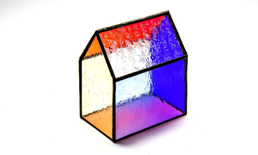 a multicolored cube sitting on top of a white table